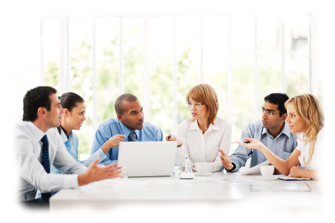 Picture of six busiess people sitting around a desk. One of them has a laptop 